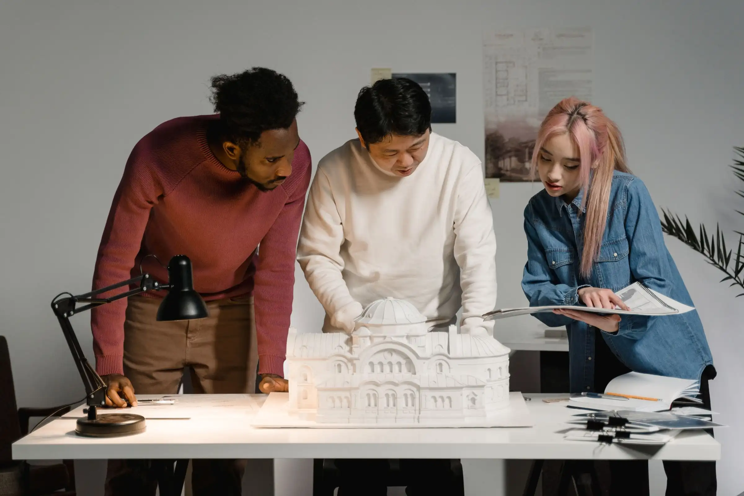 Team reviewing an architectural model in the office