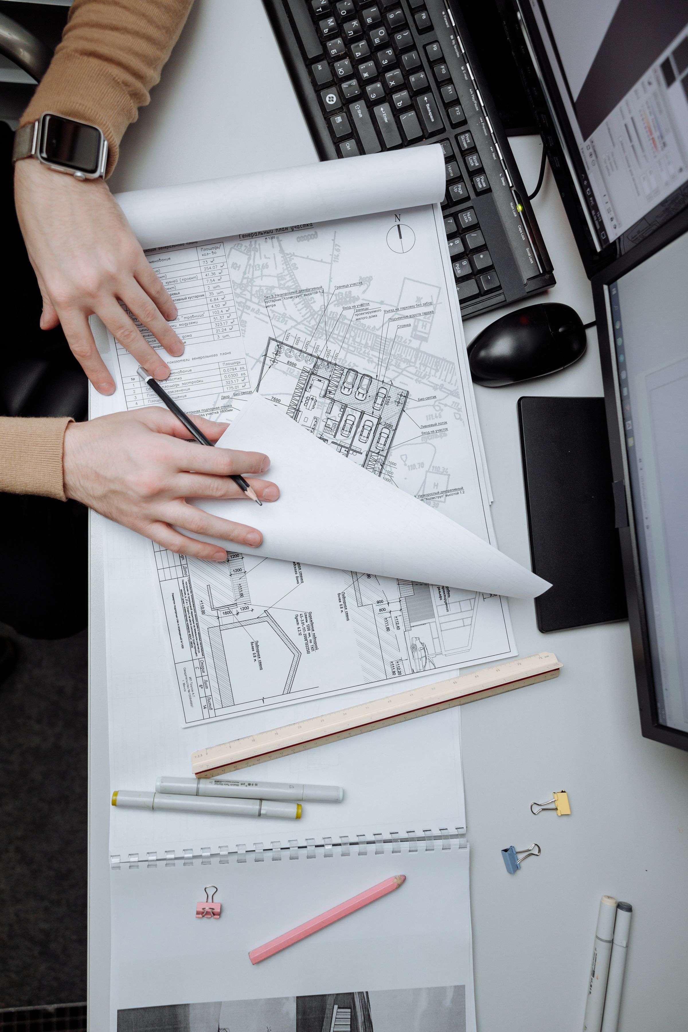 Architect reviewing construction drawings at a desk
