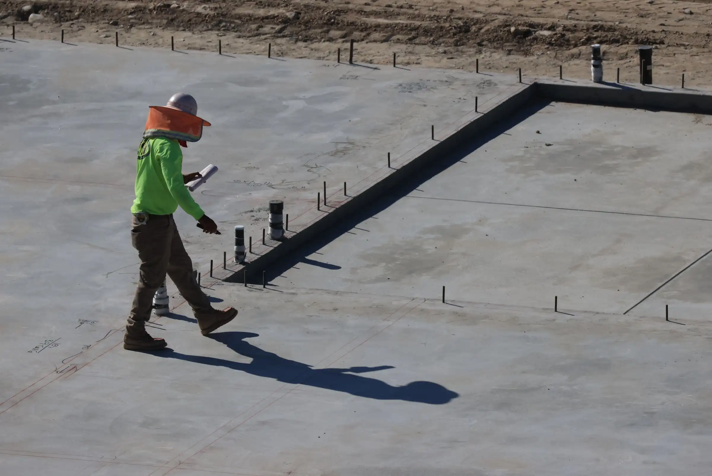 Engineer inspecting a concrete slab on site