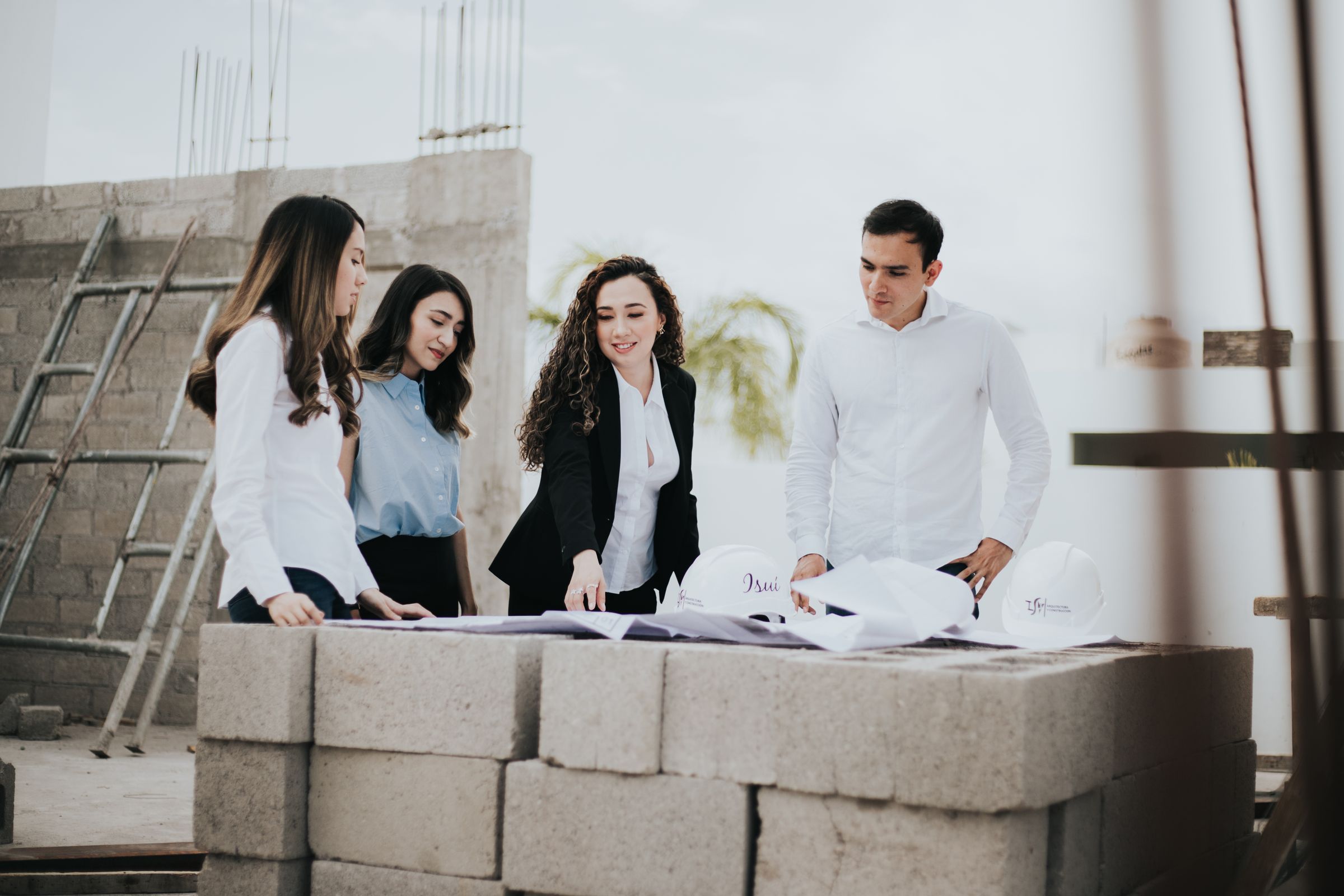 Project team reviewing drawings at a construction site